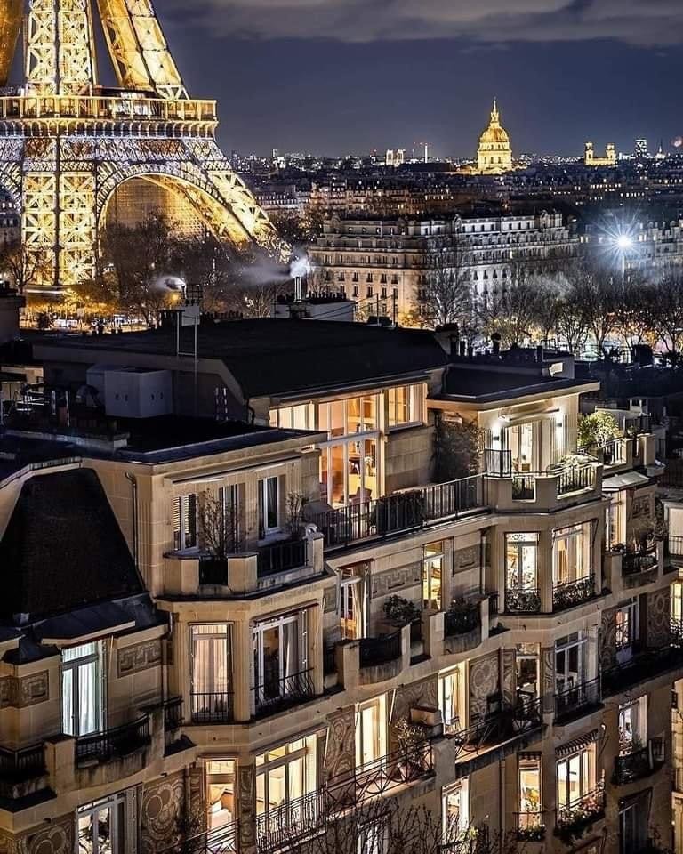 view of the Eiffel tower and Parisian buildings, from a window. Photo credit by @raphaelmetivet